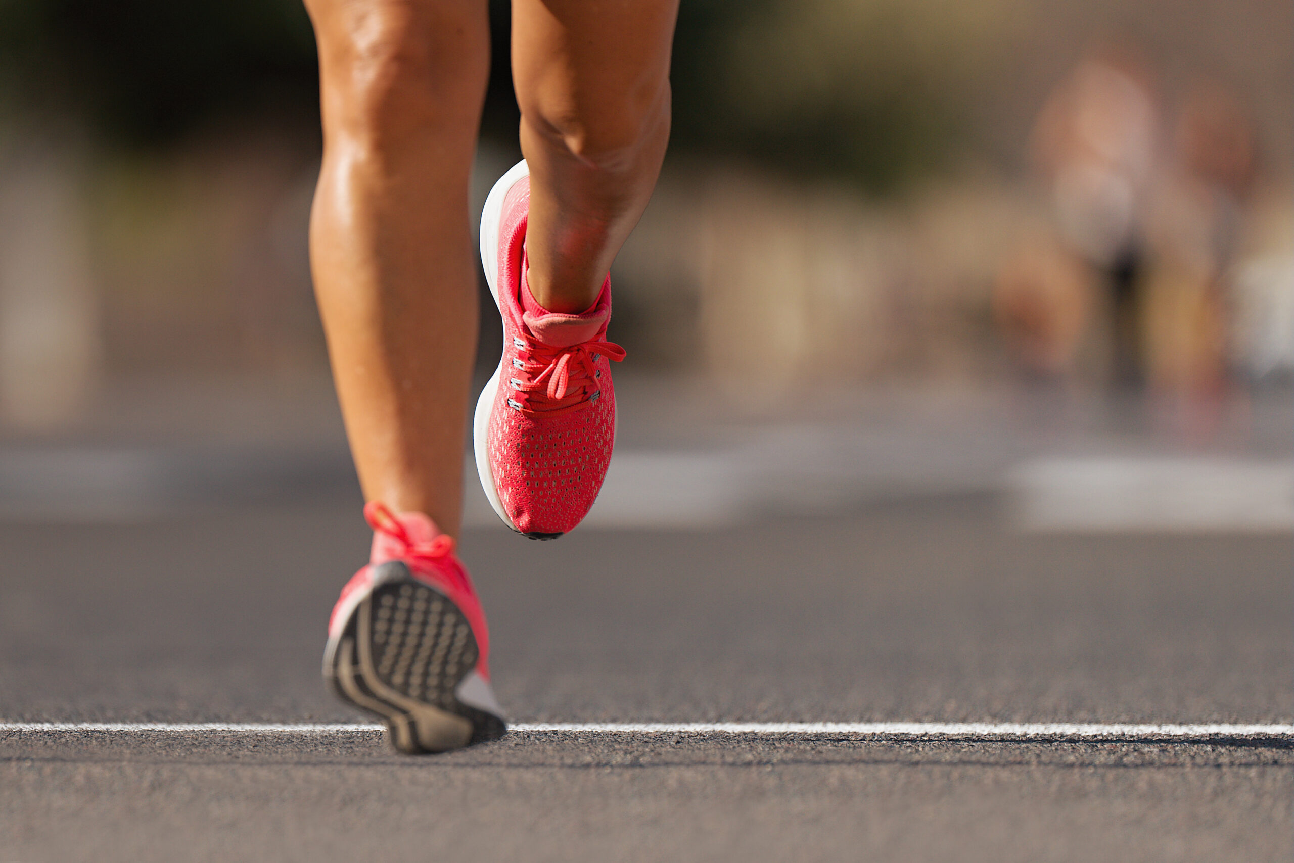 athlete runner feet running on road close up on shoe , marathon