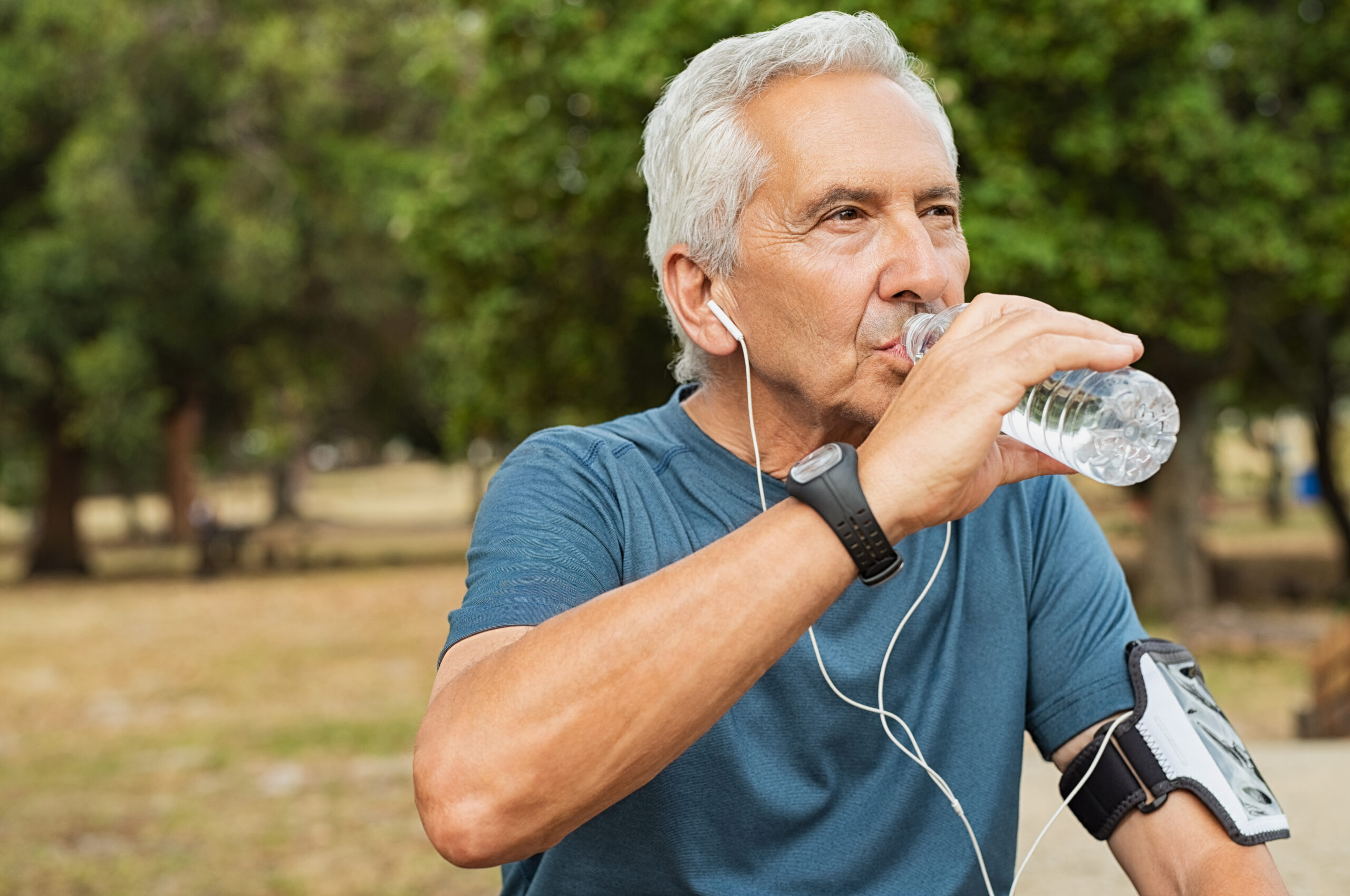 Fit Thirsty Senior Man Drinking Water Before Running. Active Old